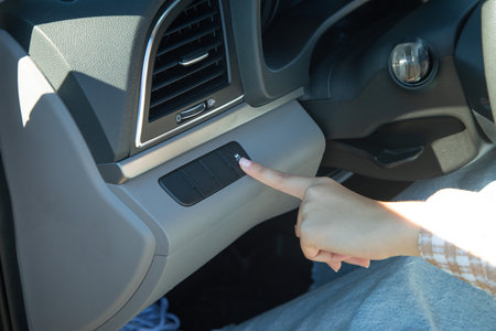 Female hand press car button.