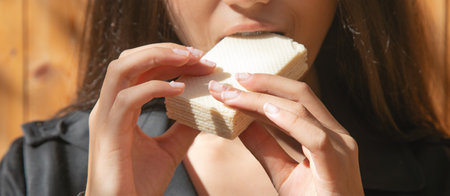 Caucasian young girl eating waffles.の写真素材