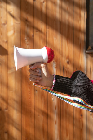 Caucasian young woman holding megaphone.の写真素材