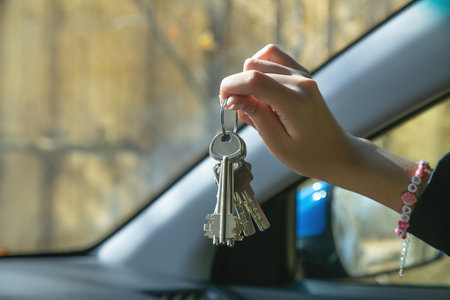 Caucasian female hand showing house keys.