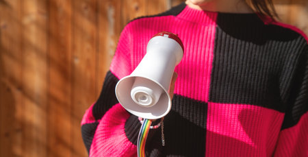 Caucasian young woman holding megaphone.の写真素材