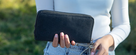 Young woman showing wallet. fashion