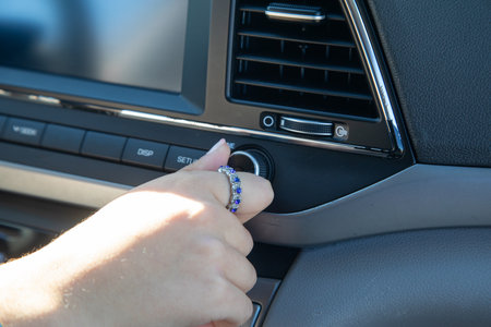 Female hand press car button.