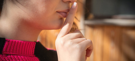 Female finger on her lips. Silenceの写真素材