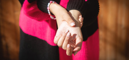 Young caucasian woman suffering from pain in hand.