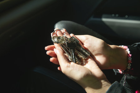 Caucasian female hand showing house keys.の写真素材