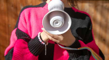Caucasian young woman holding megaphone.の写真素材