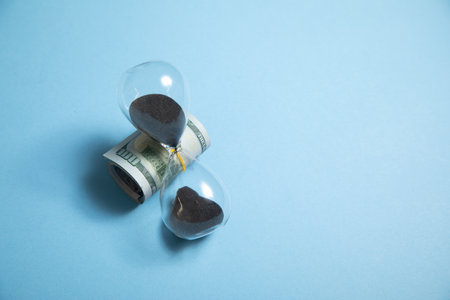 Hourglass and dollar. Time is moneyの写真素材