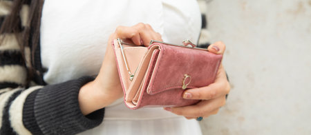 Young woman holding empty wallet. no moneyの写真素材