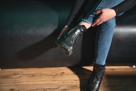Woman trying on winter boots at home.の写真素材