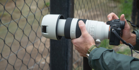 Man taking picture by professional camera in outdoor.