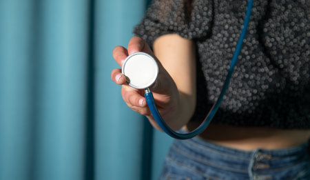 Caucasian woman holding a medical stethoscope.の写真素材