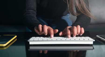 Caucasian female hands typing in computer keyboard.の写真素材