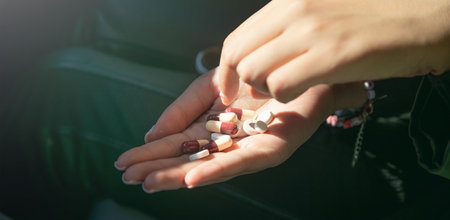 Caucasian female hand showing pill. Healthcare. Medicalの写真素材