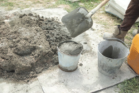 Worker mixing concrete in the construction site.の写真素材