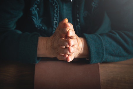 Caucasian elderly woman hands with bible.の写真素材