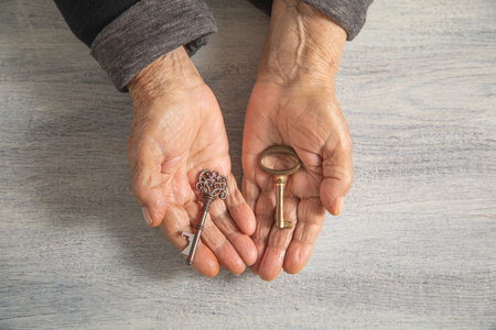 Elderly female hand with an old key.の写真素材