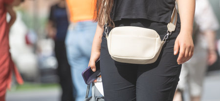 Woman with a bag on a city street.の写真素材