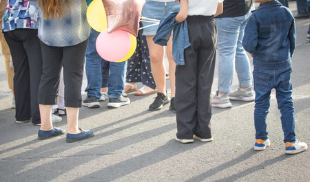 Little child with a balloon walking in the city.