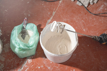Mixing of putty. Construction mixer in a bucketの写真素材