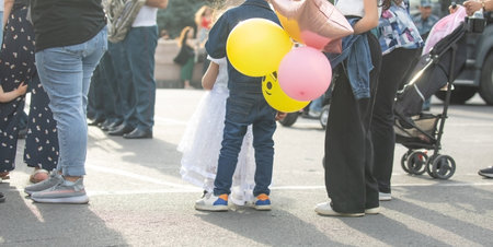 Little child with a balloon walking in the city.の写真素材