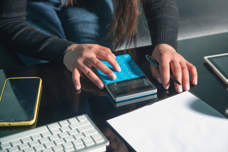 Woman using calculator. Planning budgetの写真素材