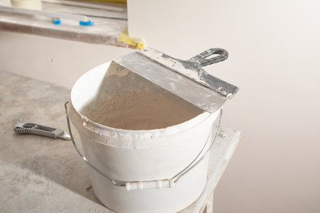 Bucket with a spatula for leveling.の写真素材