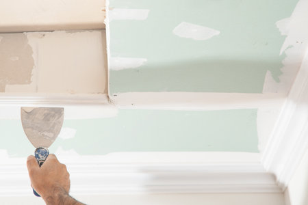 Caucasian worker renovating ceiling at home.の写真素材