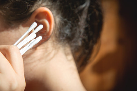 Caucasian young woman holding cotton bud.の写真素材