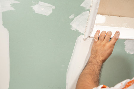 Caucasian worker renovating ceiling at home.の写真素材