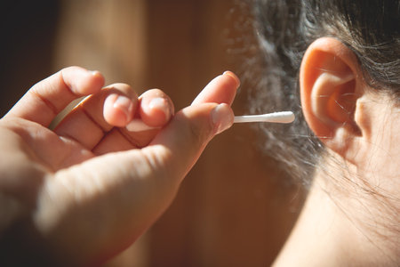 Caucasian young woman holding cotton bud.の写真素材