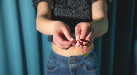 Young caucasian woman measuring her body.の写真素材