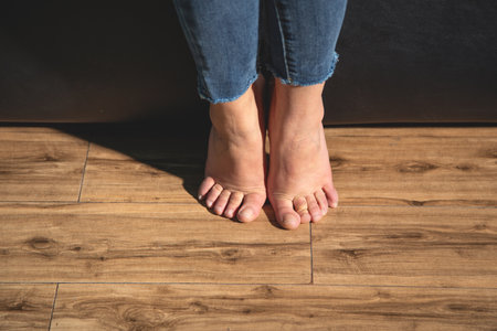 Barefoot woman walking on floor at home.の写真素材