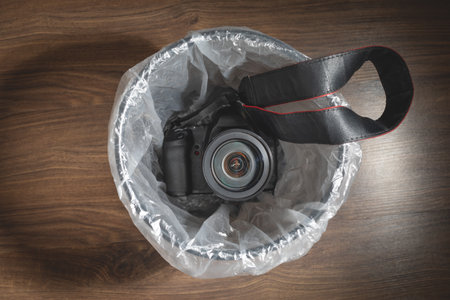 Professional dslr camera and trash can.の写真素材