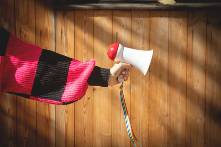 Caucasian young woman holding megaphone.の写真素材