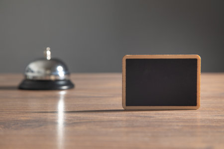 Empty board and service bell on the table.の写真素材