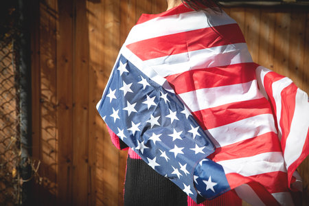 Caucasian young woman with a Us flag.の写真素材