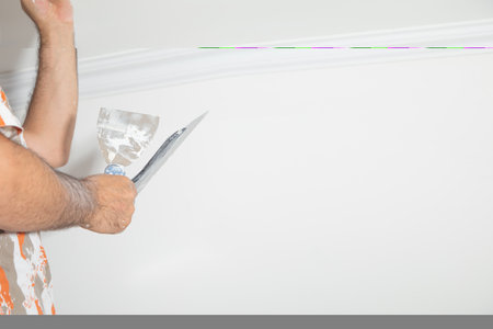 Caucasian worker renovating ceiling at home.の写真素材