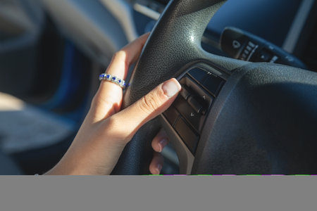 Female hands in steering wheel of car.の写真素材