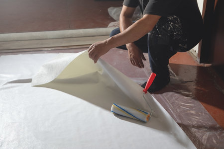 Worker prepare wallpaper in house renovation.の写真素材