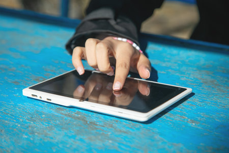 Caucasian young woman using tablet.