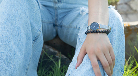 Young woman wearing wristwatch in the outdoor.の写真素材