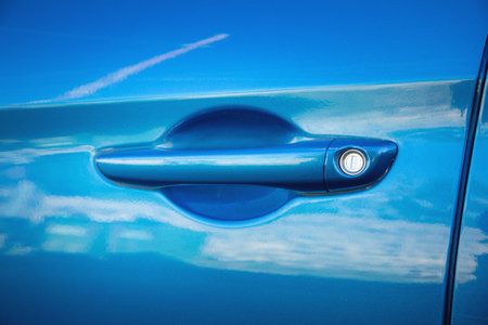 Close up a metallic blue car door handle.の写真素材