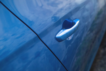 Close up a metallic blue car door handle.の写真素材