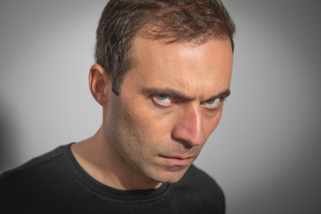 Caucasian angry man looking at camera.