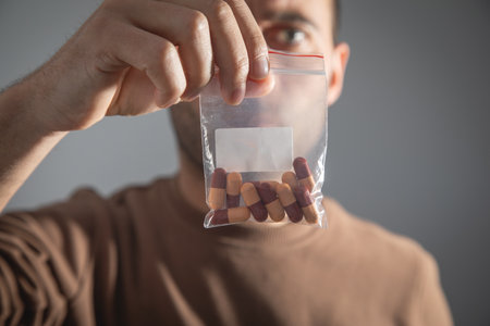 Caucasian man showing medical pill.の写真素材