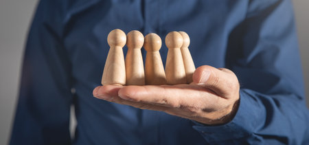 Businessman showing wooden human figure.の写真素材