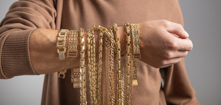 Caucasian man with a golden necklace.