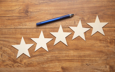 Wooden 5 stars on the workplace. Customer satisfactionの写真素材