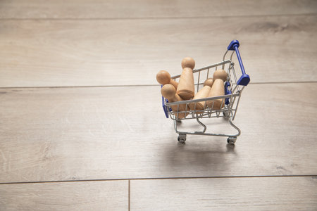 Shopping cart with a wooden human figures.の写真素材